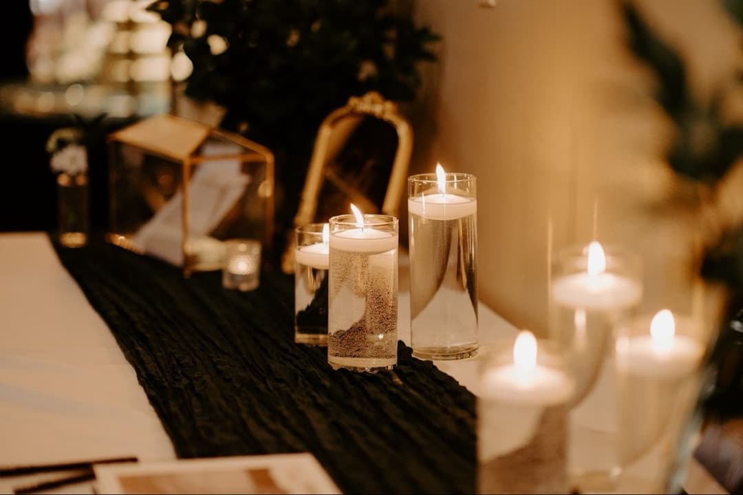 Elegant table setting with floating candles and soft lighting for a cozy ambiance.